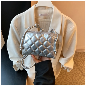 Detail of silver metallic crossbody bag with diamond quilted pattern and crystal studs