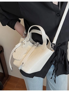 Classic white crocodile pattern bucket bag with a bear charm and detachable strap