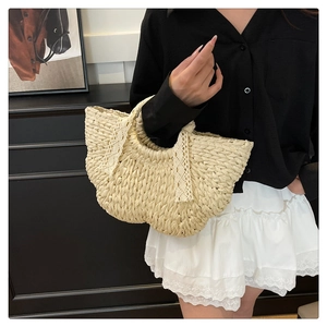 Detail of hand-woven straw handbag with white lace trim for summer beach vacation style