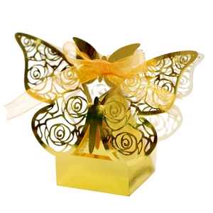 Detailed laser-cut golden favor box with rose patterns and butterfly wing design