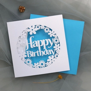 Detailed laser-cut pearl paper birthday card with floral patterns and blue envelope