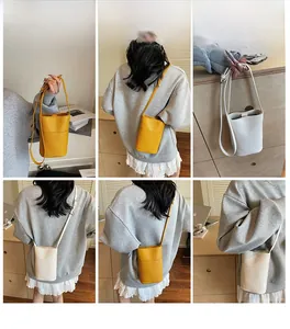 Detail shot of mini bucket bags in yellow and cream with textured lychee leather finish