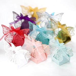 Macro shot of laser-cut butterfly gift boxes with intricate floral patterns and ribbons