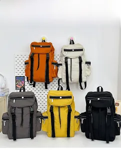Detailed view of water-resistant travel backpacks in orange, beige, grey, yellow, and black