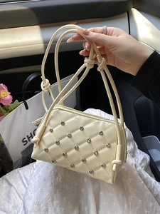 Chic beige quilted crossbody bag with rhinestone studs and knotted strap detail