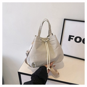 Close-up of lightweight nylon drawstring bucket bag with adjustable shoulder strap