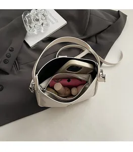Top-down view showing internal storage capacity of the beige faux leather hobo bag