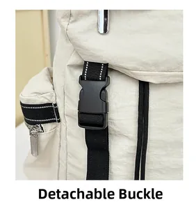 Close-up of detachable black plastic buckle and beige nylon fabric on travel backpack