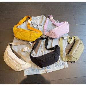 Top view of colorful nylon chest bags with quick-release buckles on denim background