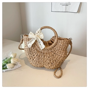 Detail of hand-woven straw bag texture with elegant lace bow and drawstring inner lining