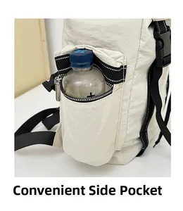 Close-up of beige travel backpack side pocket with water bottle and black zipper detail