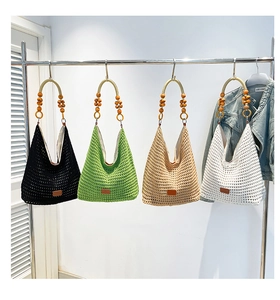 Detail of wooden bead handle and hollow knit texture on stylish woven tote bags