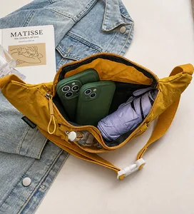 Detail showing the large storage capacity of this yellow nylon crossbody sling bag