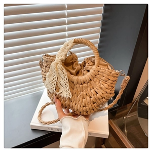 Détail du sac en paille tressé à la main avec nœud en dentelle et doublure intérieure
