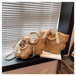 Three-piece set of semi-circular straw woven bags in various sizes with lace bow details