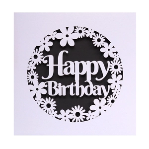 Detail of laser-cut daisy pattern and Happy Birthday lettering on white cardstock