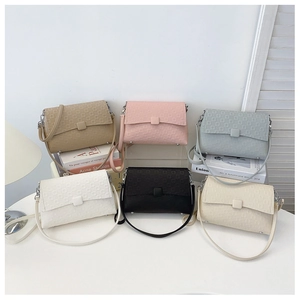 Detail showing vintage shoulder bags in six colors with square embossed textures