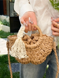 Handmade straw half-moon bag with lace detail and drawstring lining for summer beach vacations