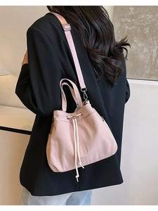 Pink drawstring nylon bucket bag with adjustable shoulder strap for women's daily travel
