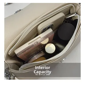 Internal view showing capacity of off-white faux leather shoulder bag with zipper pocket