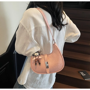 Pink pleated leather crescent bag with silver twist lock and cute doll charm accessory