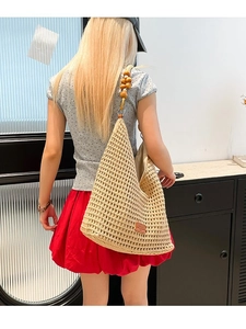 Large beige hollow crochet knit tote bag with wooden bead straps and bohemian style