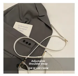 Detail of white leather shoulder bag with adjustable strap and premium gold buckle