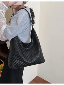 Large black woven leather tote bag with V-pattern for summer travel and daily commute