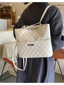 Quilted cream tote backpack with diamond stitching and adjustable shoulder straps