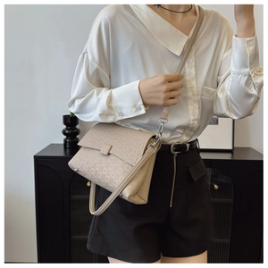 Chic beige crossbody bag with quilted pattern shown on model for size perspective