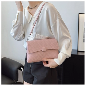 Pink embossed PU leather underarm bag shown on model with white shirt and black shorts
