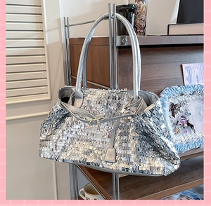 Detail shot of the shimmering silver sequin tote bag with metallic reflective texture