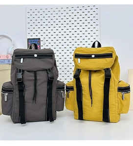 Dual view of large outdoor backpacks in dark grey and yellow with buckle closures