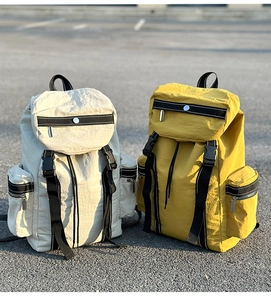 Outdoor leisure backpacks in yellow and beige with buckles and metal zippers detail