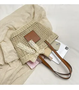 Detail of hollow woven straw tote with large capacity for tablet and phone