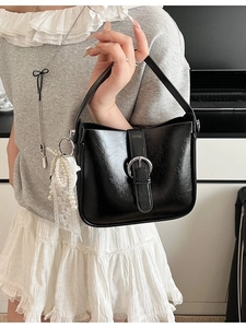 Black minimalist shoulder bag with silver buckle and pearl lace charm accessory
