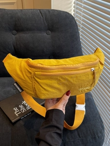 Minimalist bright yellow nylon waist bag featuring a trendy pleated design and shoulder strap