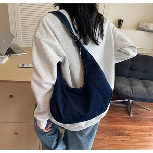 Deep blue denim hobo bag featuring large capacity and slouchy design for casual wear