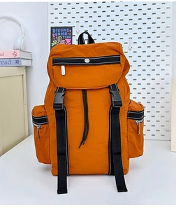Detailed view of durable orange nylon hiking backpack with multiple functional zip pockets
