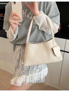 Beige woven leather tote bag with a small pouch and matching top handle