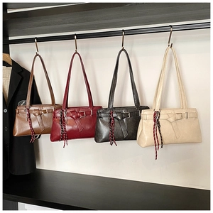 Detailed row of stylish underarm bags in brown, burgundy, grey, and beige finishes