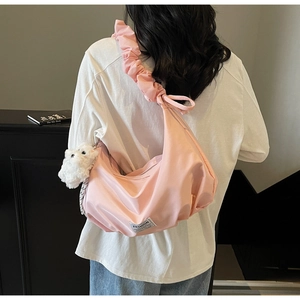 Pink cloud bag with ruched shoulder strap and cute bear charm shown in a back view