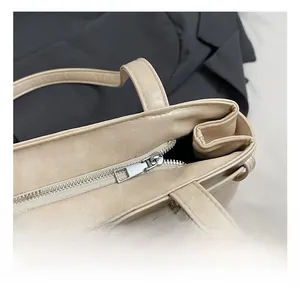 Detail of premium silver zipper and matte cream faux leather on the shoulder bag