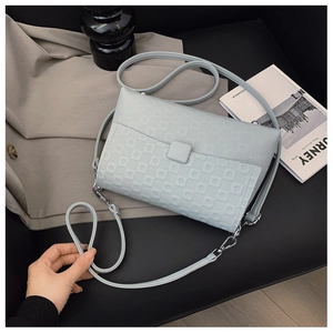 Detail of light blue faux leather texture with geometric circular embossed patterns