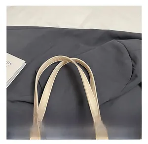 Detail of light beige leather handbag handle with durable double stitching craft