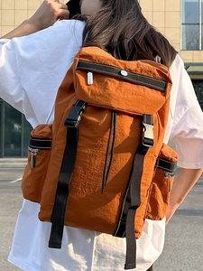 Burnt orange outdoor hiking backpack in lightweight nylon with reflective buckle straps