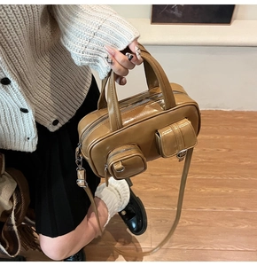 Detailed close-up of retro leather handbag featuring dual functional front pockets
