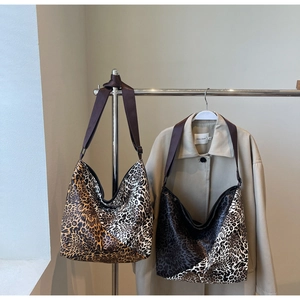 Close-up of leopard print canvas tote bags in brown and grey with durable straps
