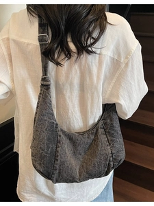 Retro grey washed denim crescent shoulder bag with adjustable strap worn by a model