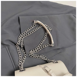 Detail view of off-white crossbody bag with silver chain strap and metallic buckle design